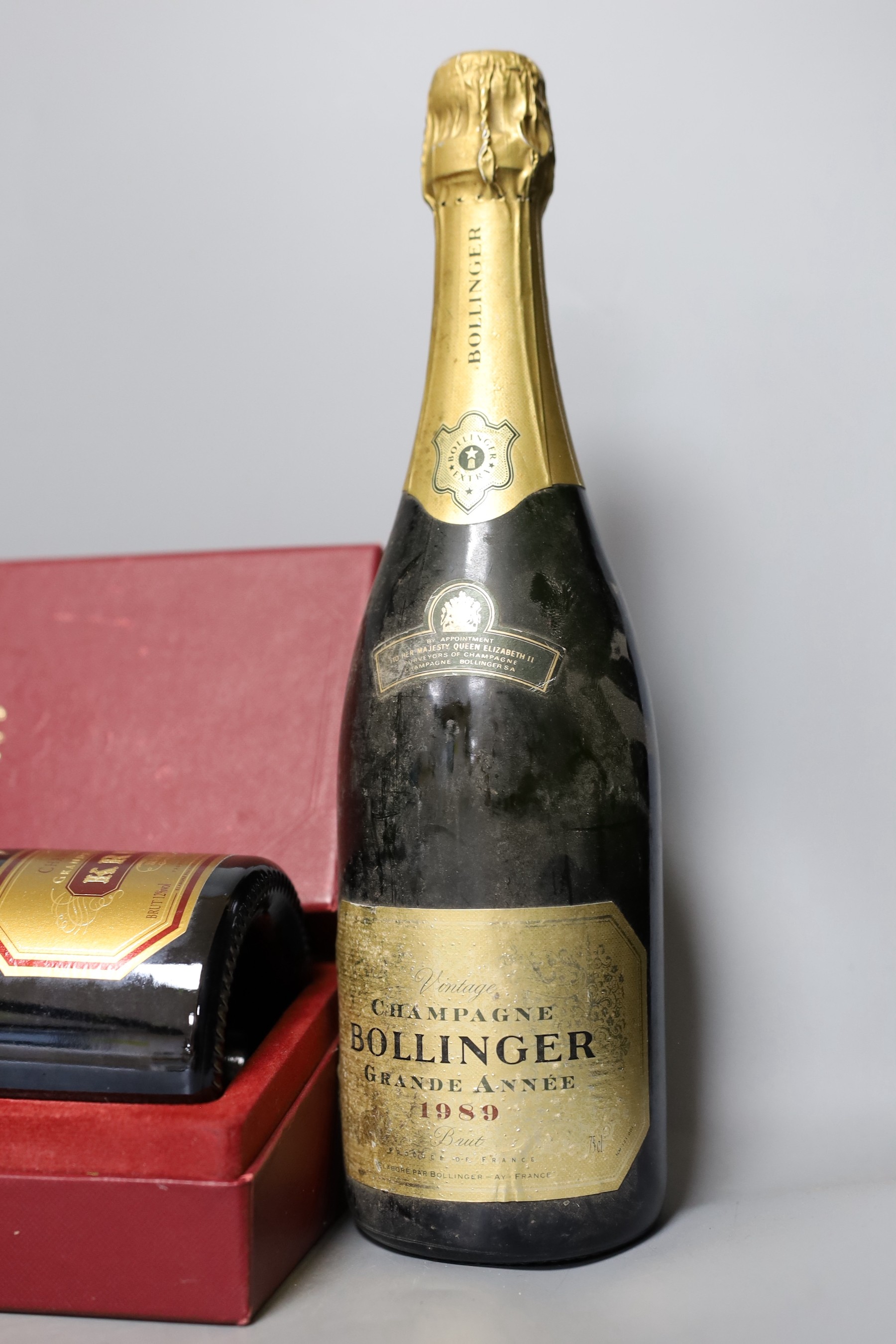 One bottle of Bollinger vintage champagne, 1989, one boxed bottle of Krug (NV) and a bottle of 2004 Pouilly Fuisse